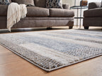 Gray area rug with mottled pattern and light vertical bands