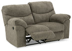 Reclining loveseat in gray fabric with pull-out footrest and rounded armrests