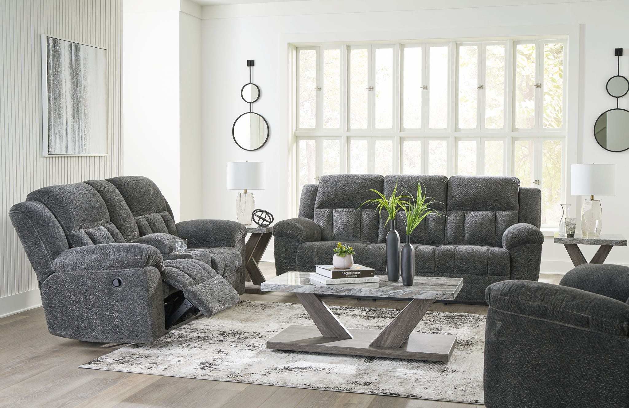 Reclining living room set with dark gray recliner sofa and matching recliner loveseat