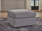Gray upholstered accent ottoman with thick cushion and squared edges