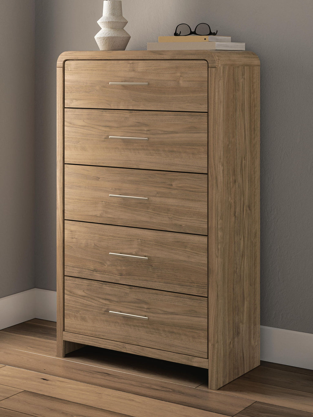Five-drawer chest in warm natural brown wood with five metal bar pulls, front view.