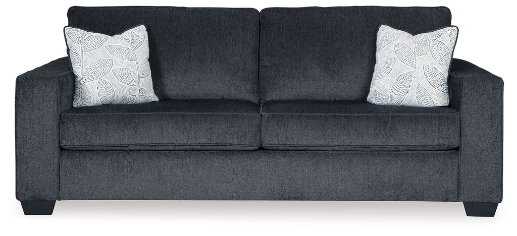 Slate stationary sofa with square arms, tufted back, and two light patterned throw pillows