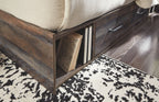 Dark wood bed frame showing an open storage compartment under the rail