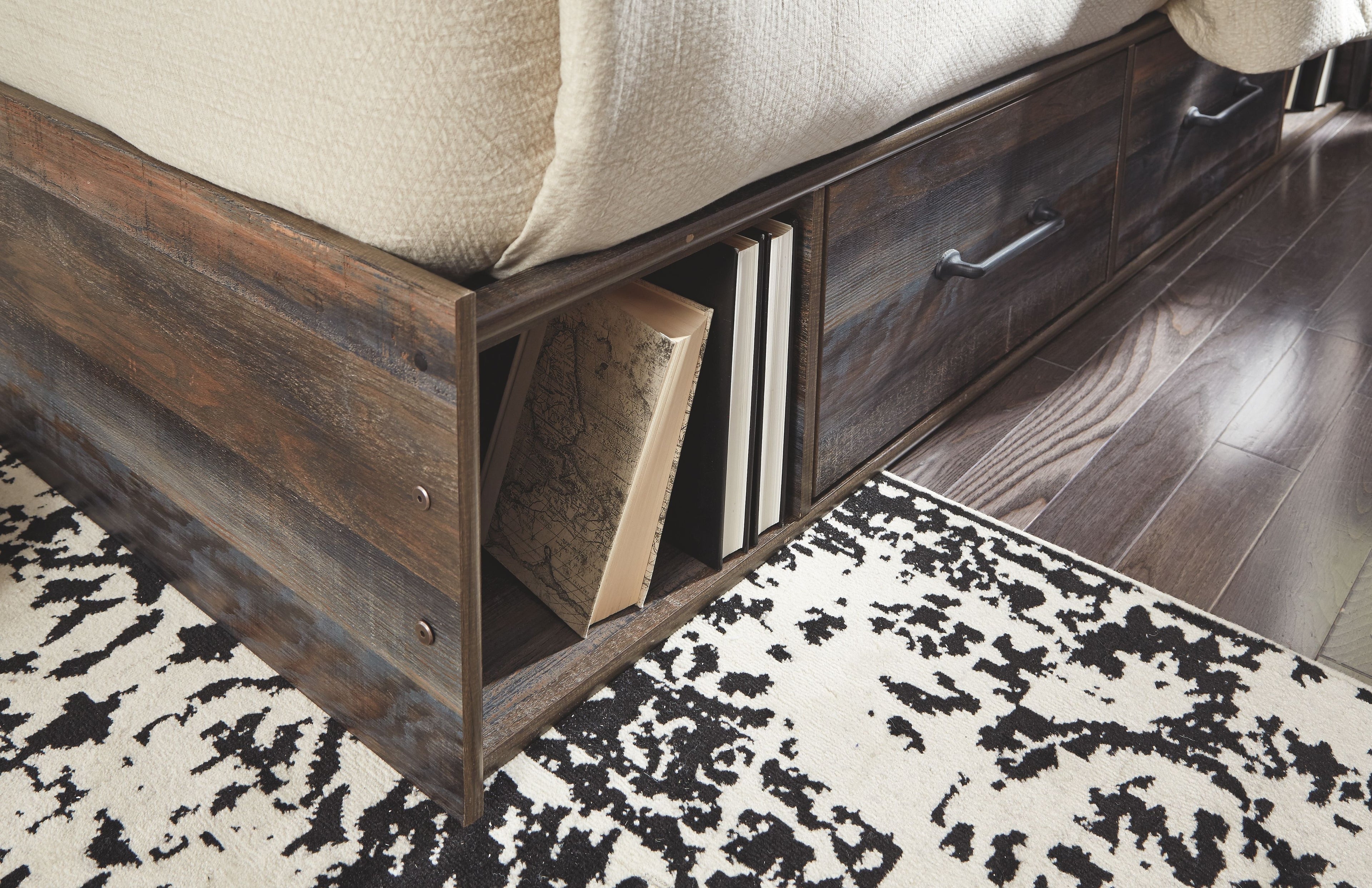 Dark wood bed frame showing an open storage compartment under the rail