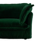Green sectional side view with ribbed slipcover and draped fabric trim