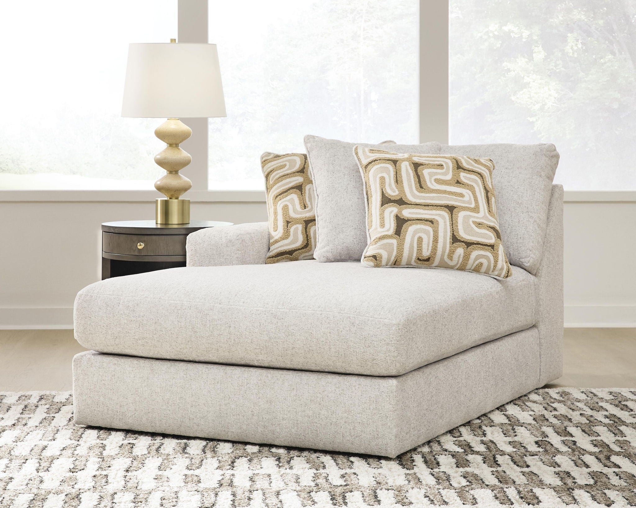 Light beige corner chaise seat with two patterned back cushions