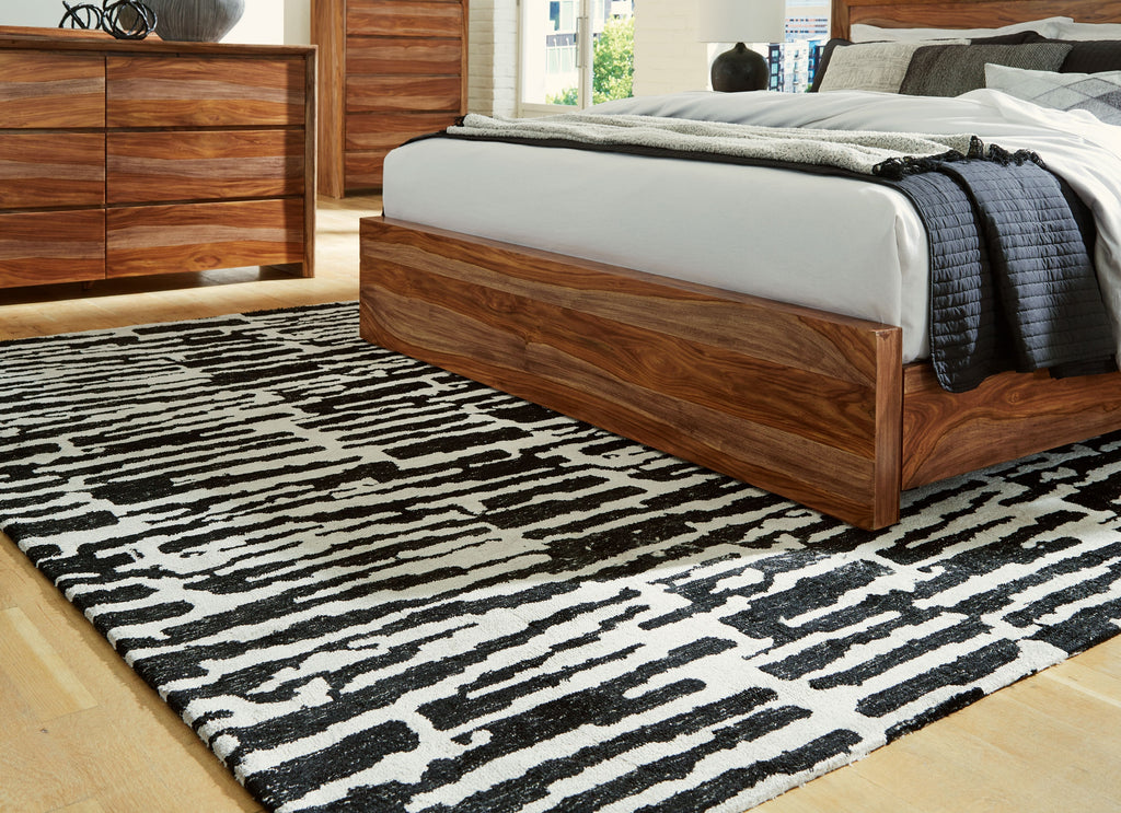 Black-and-white abstract striped area rug with irregular blocks, full coverage