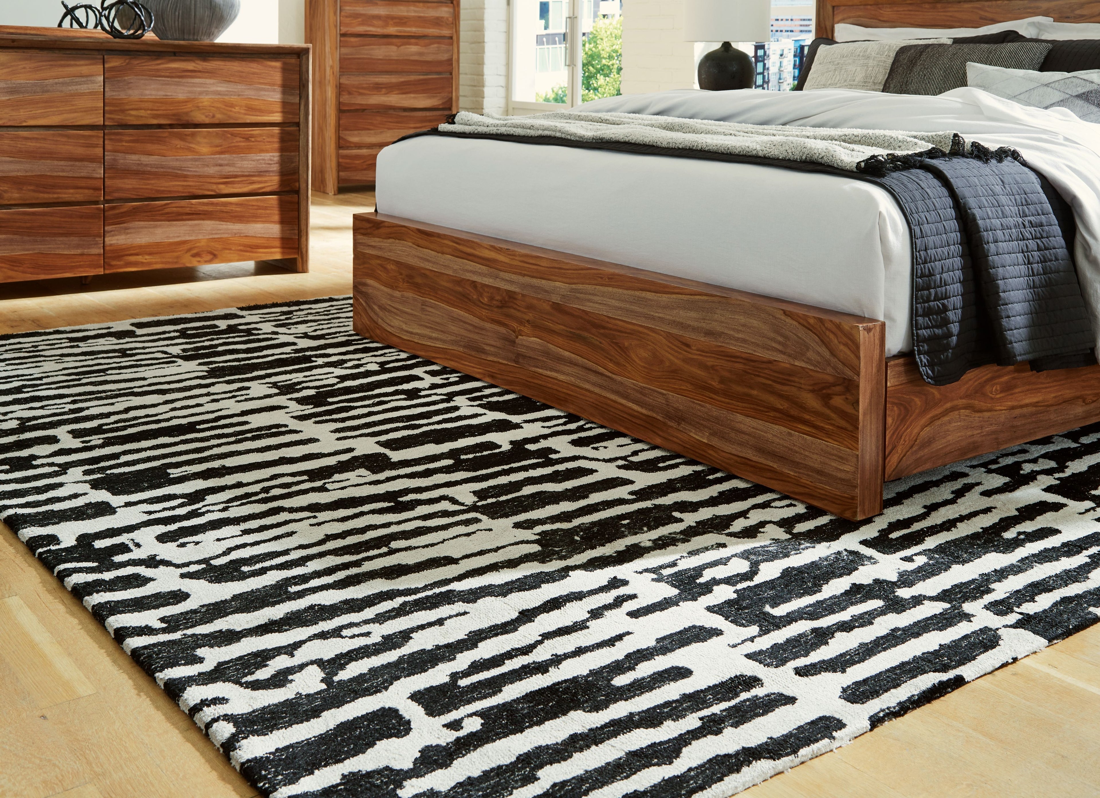 Black-and-white abstract striped area rug with irregular blocks, full coverage