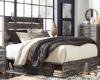 Dark wood panel bed with slatted headboard and side rails, quilted bedding and pillows