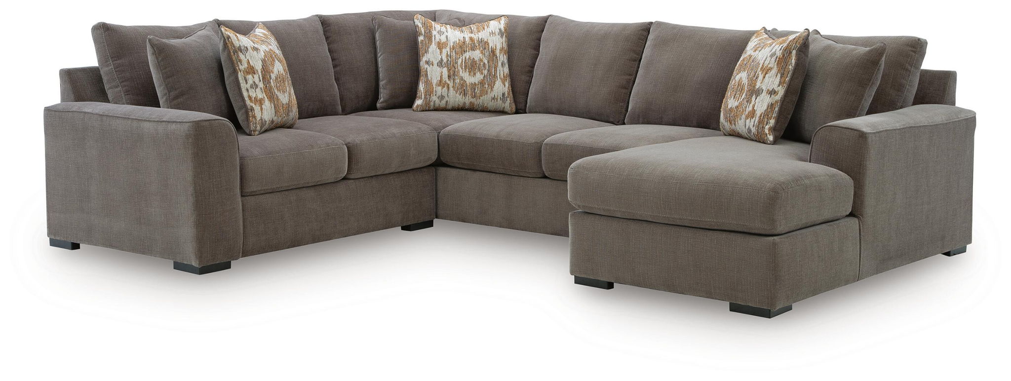 Gray sectional sofa with chaise and tufted cushions, plus patterned throw pillows