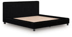 Upholstered bed frame with black ribbed sides and beige upholstered mattress base