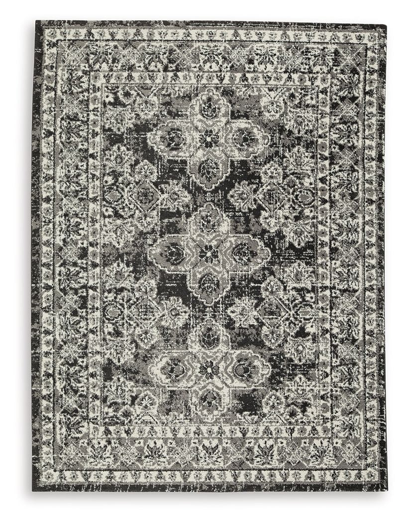 Glennisman rug, rectangular vintage medallion pattern in gray with dark accents, border