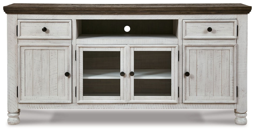 Extra-large TV stand with brown top, white doors, and open center shelves