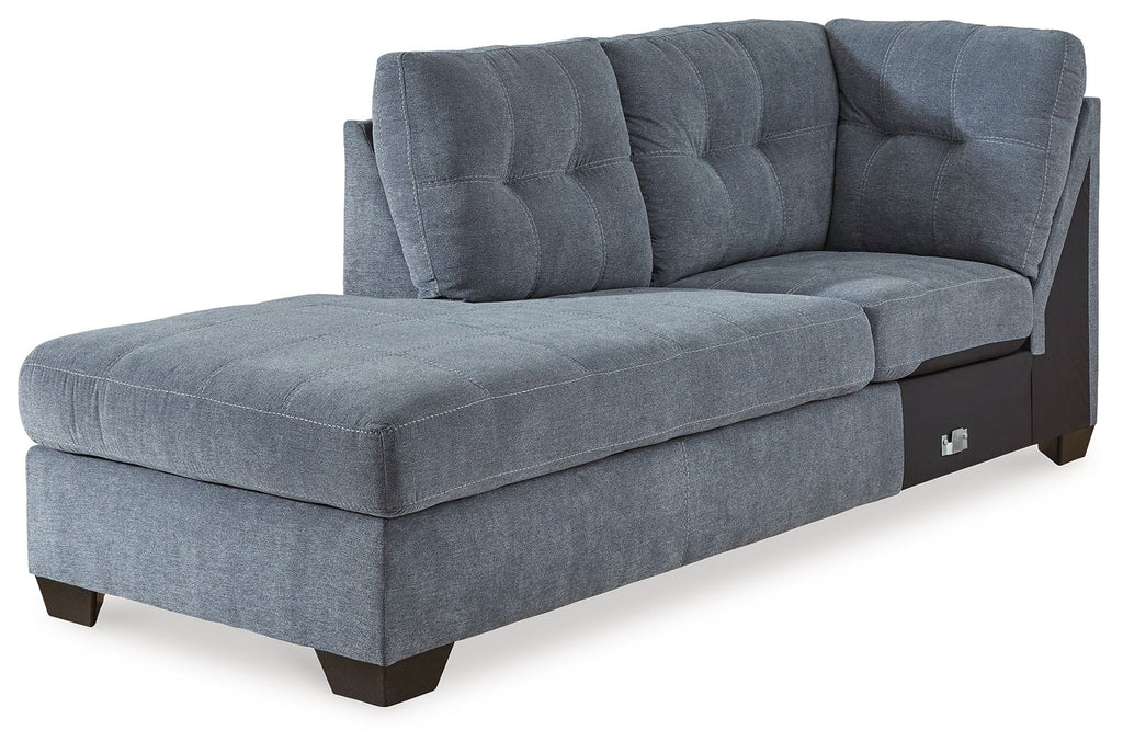 Blue denim corner chaise with tufted back, track arms, and dark wooden legs
