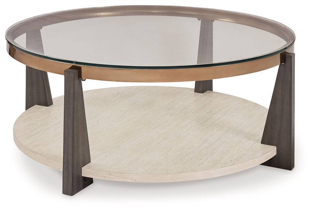 Round cocktail table with glass top, lower shelf, and dark wood legs with bronze rim