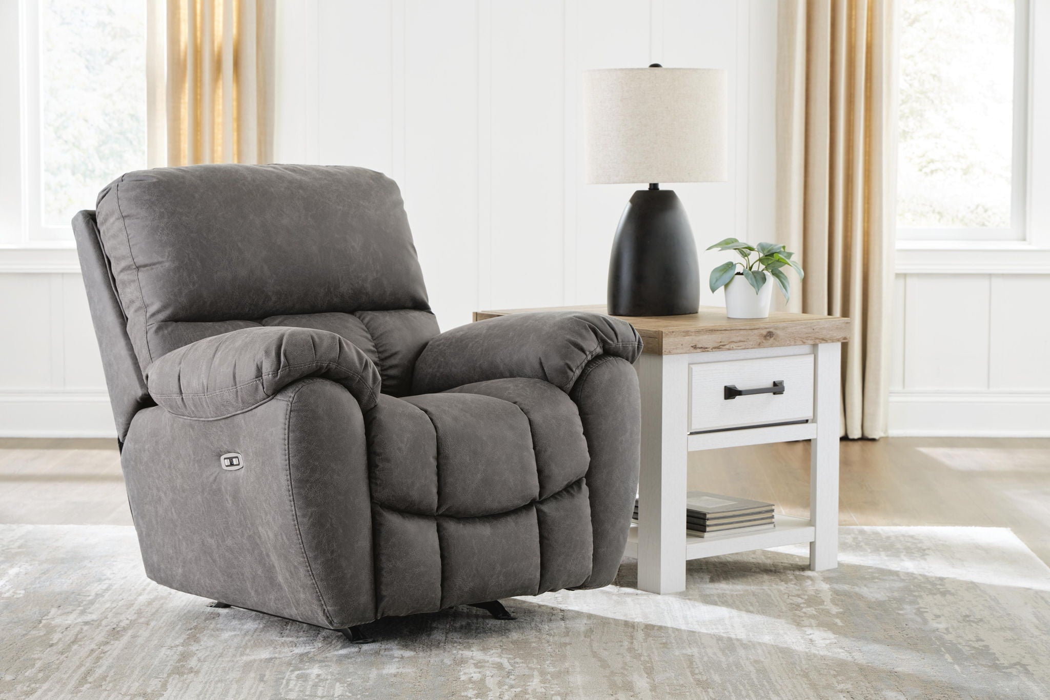 Gray fabric power rocker recliner with cushioned back, padded arms, adjustable headrest