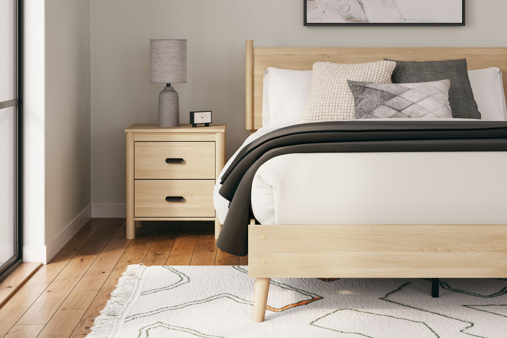 Tan queen panel headboard on bed frame with gray accent pillows and throw