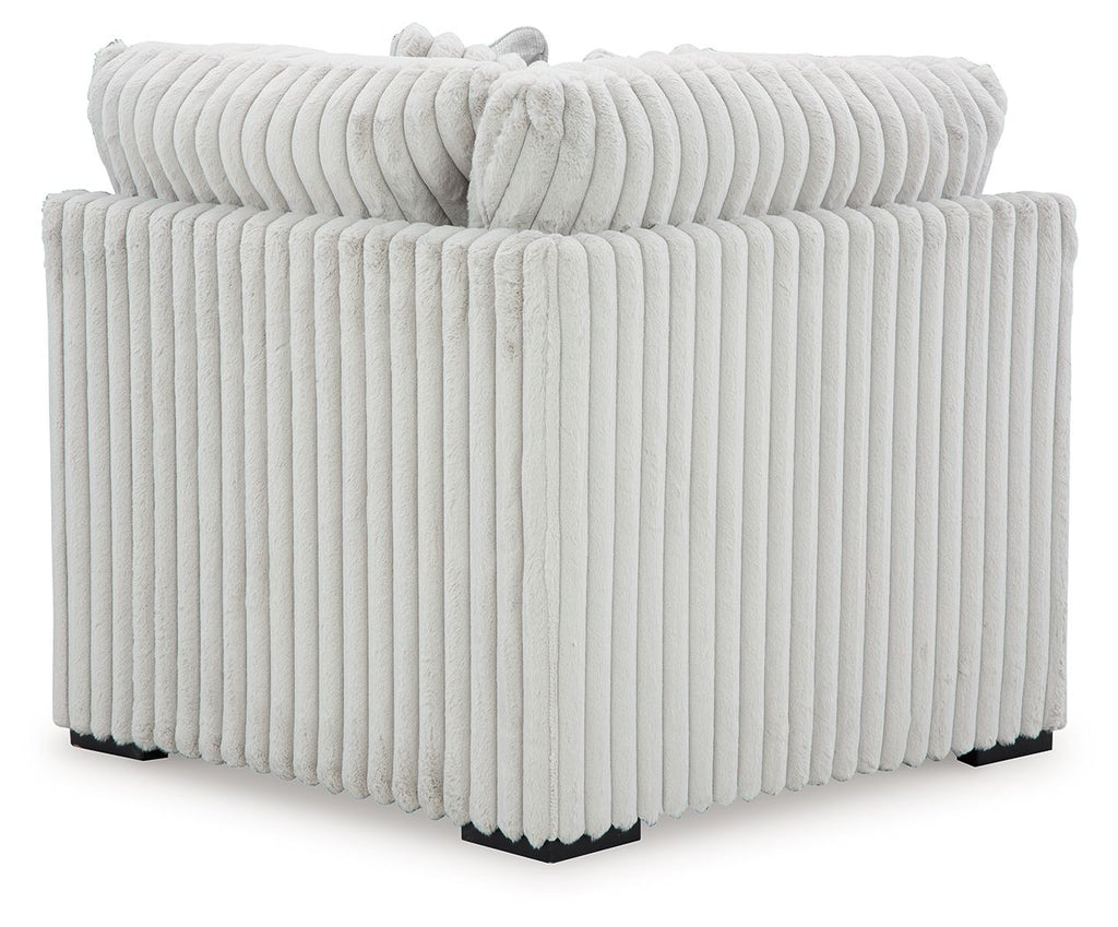Light gray ribbed upholstered sectional wedge corner piece with vertical channeling