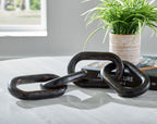 Black chain sculpture with interlocking oval links and dark sheen