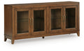Medium brown wood accent cabinet with four glass doors and brass handles