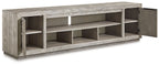 Gray TV stand angled view with a side cabinet door and open storage compartments