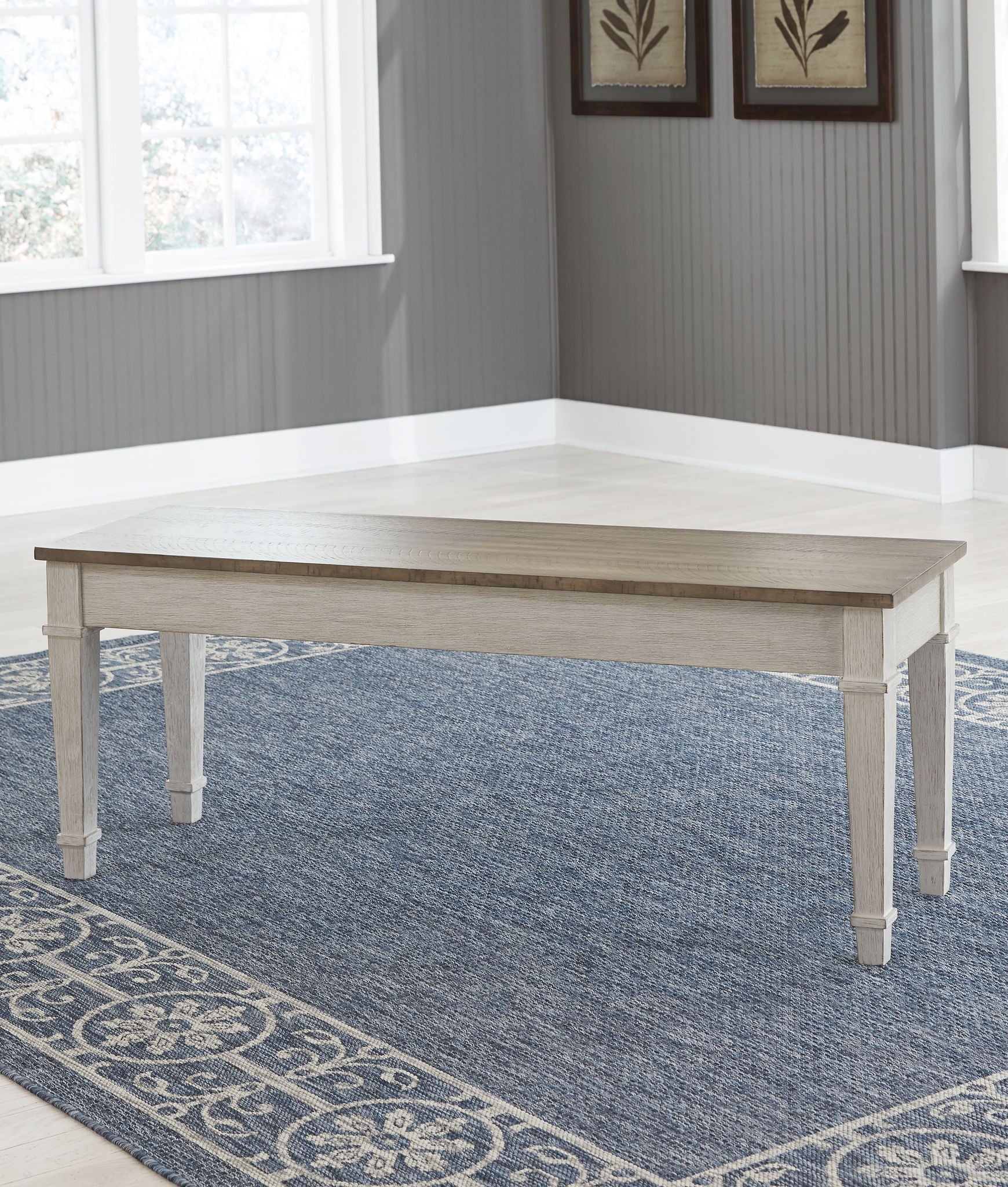 White storage bench with light wood tabletop and turned legs