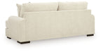 Light beige fabric sofa with wide arms and three seat cushions