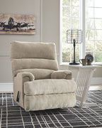 Rocking recliner chair with tall back cushion and padded arms in light fabric