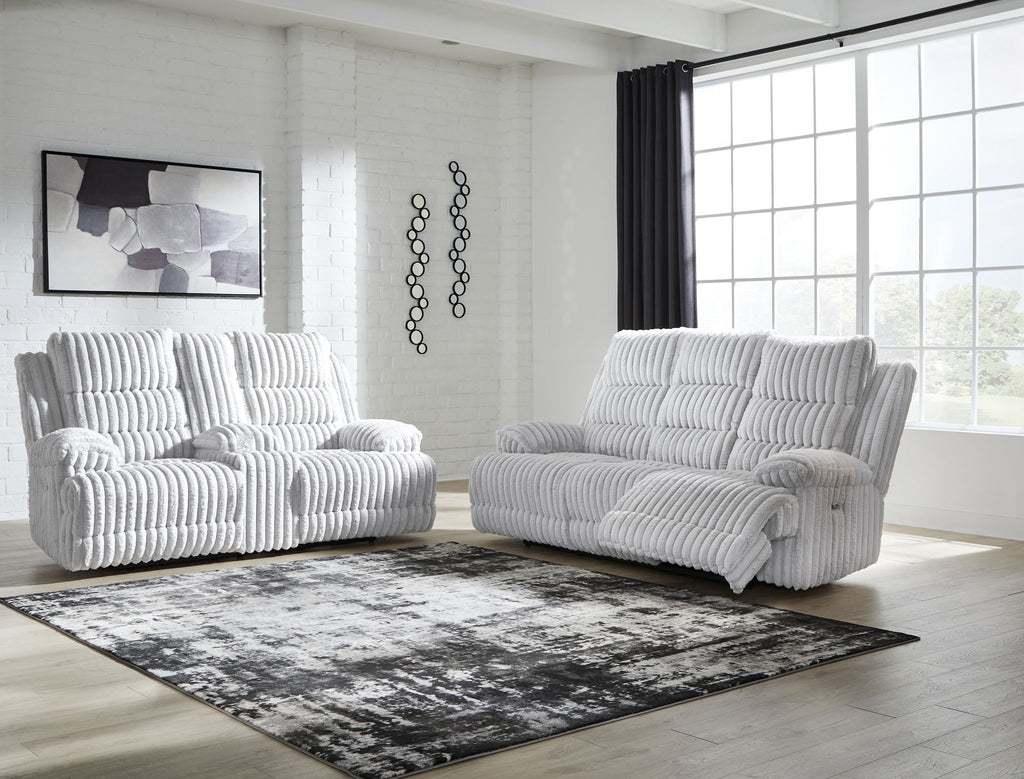 Light gray power reclining sofa and loveseat set with thick channel-tufted cushions