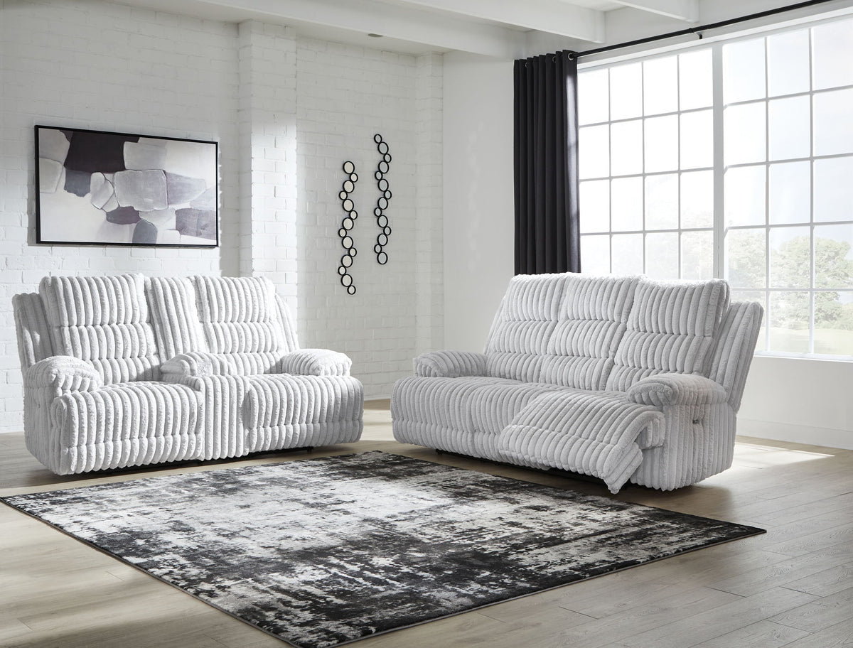 Light gray power reclining sofa and loveseat set with thick channel-tufted cushions
