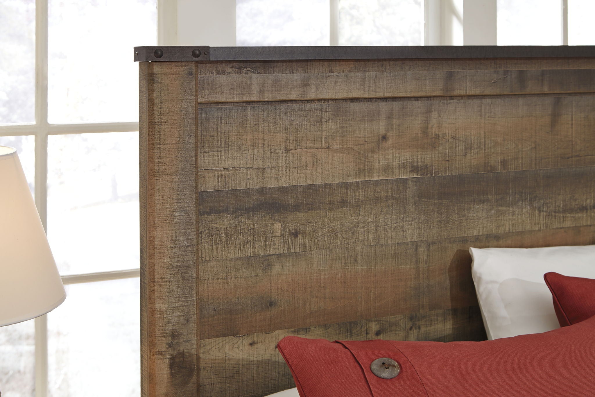 Dark brown panel bed headboard detail with raised panels and weathered wood finish