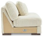 Ivory armless chair side view with ribbed cushions and two pillows