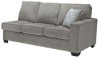 Grey fabric sofa sleeper with three seat cushions and a decorative pillow