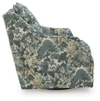 Green floral swivel accent chair shown from side angle with rounded arm and base.