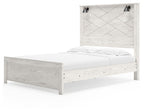 White panel bed with two black sconces, low footboard and white mattress
