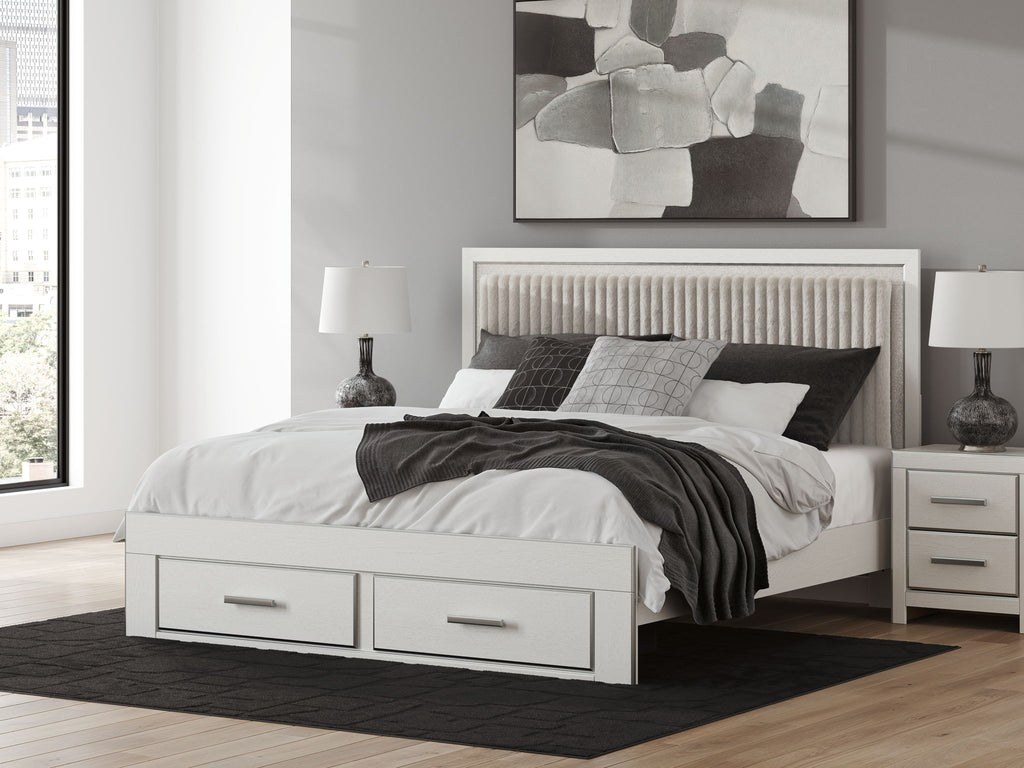 White platform bed with upholstered panel headboard and two storage drawers, front view