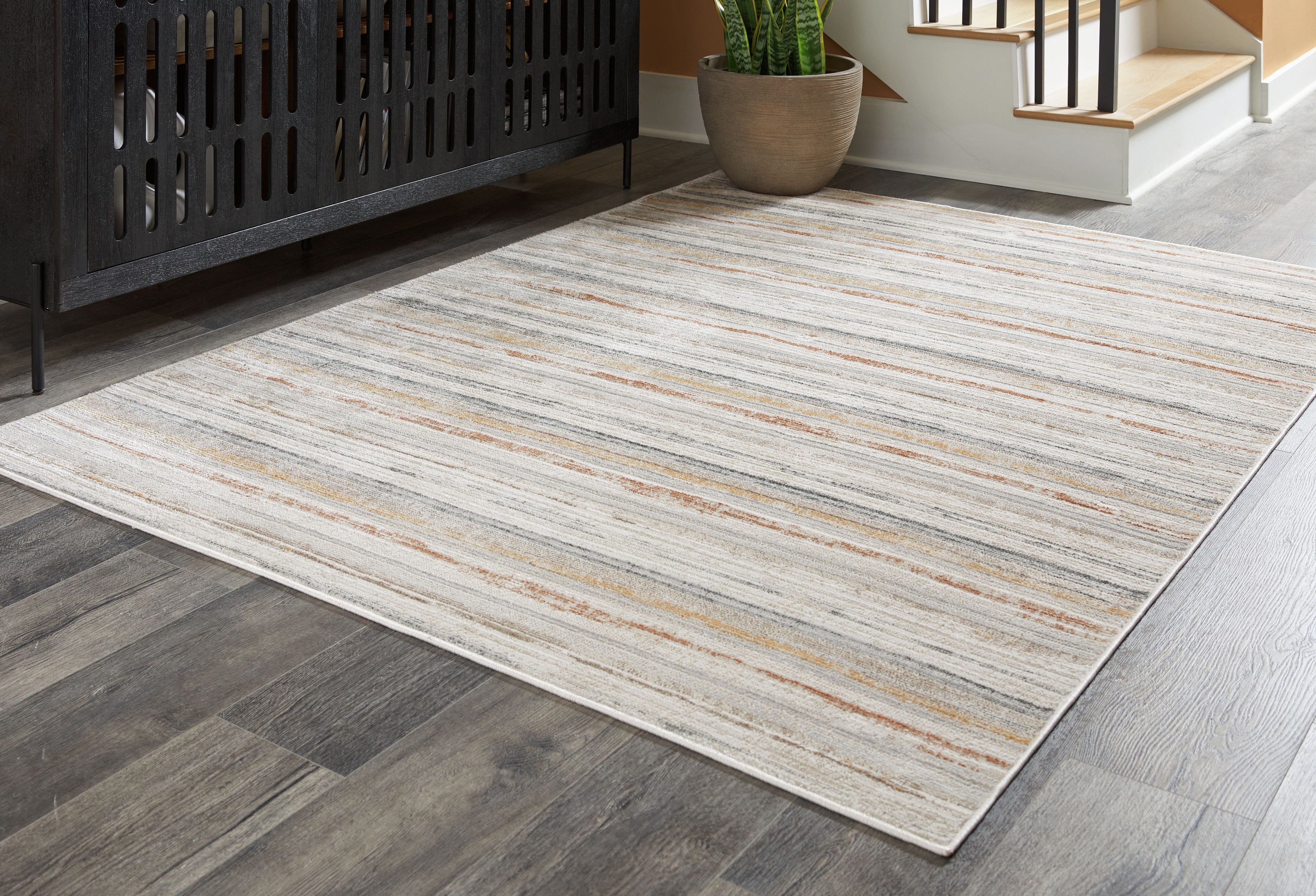 Artney rug flat on floor, light gray with light brown and cream stripe lines