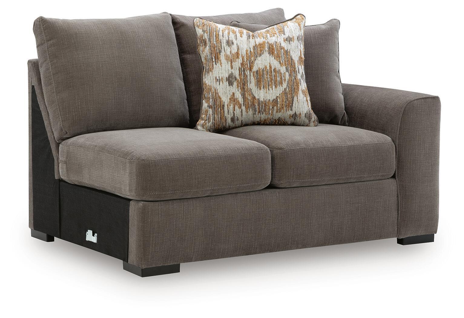 Gray fabric loveseat with two cushions and patterned square throw pillow; dark legs.
