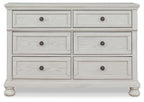Antique white dresser with six drawers and round knob pulls, layered drawer layout.