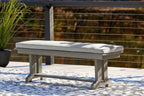 Gray outdoor bench with cushioned seat and backless bench frame, short thick legs