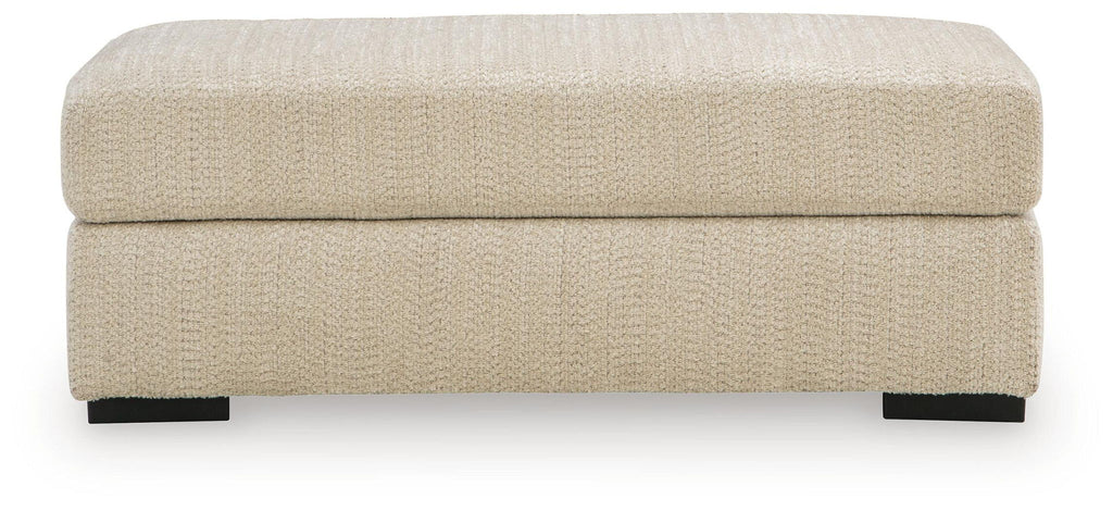 Lofwood Ottoman in textured beige fabric with low profile, square top, black feet