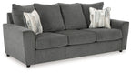 Dark gray fabric sofa with three seat cushions and five back pillows.