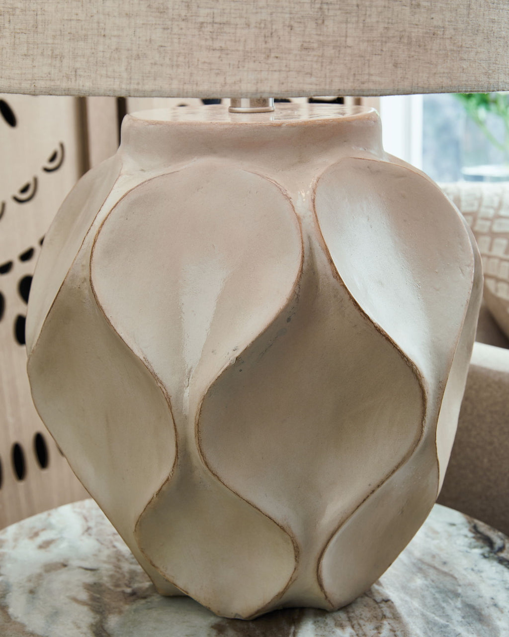 Distressed cream paper table lamp with drum shade and textured faceted base