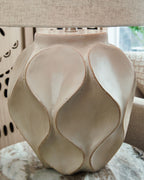 Distressed cream paper table lamp with drum shade and textured faceted base