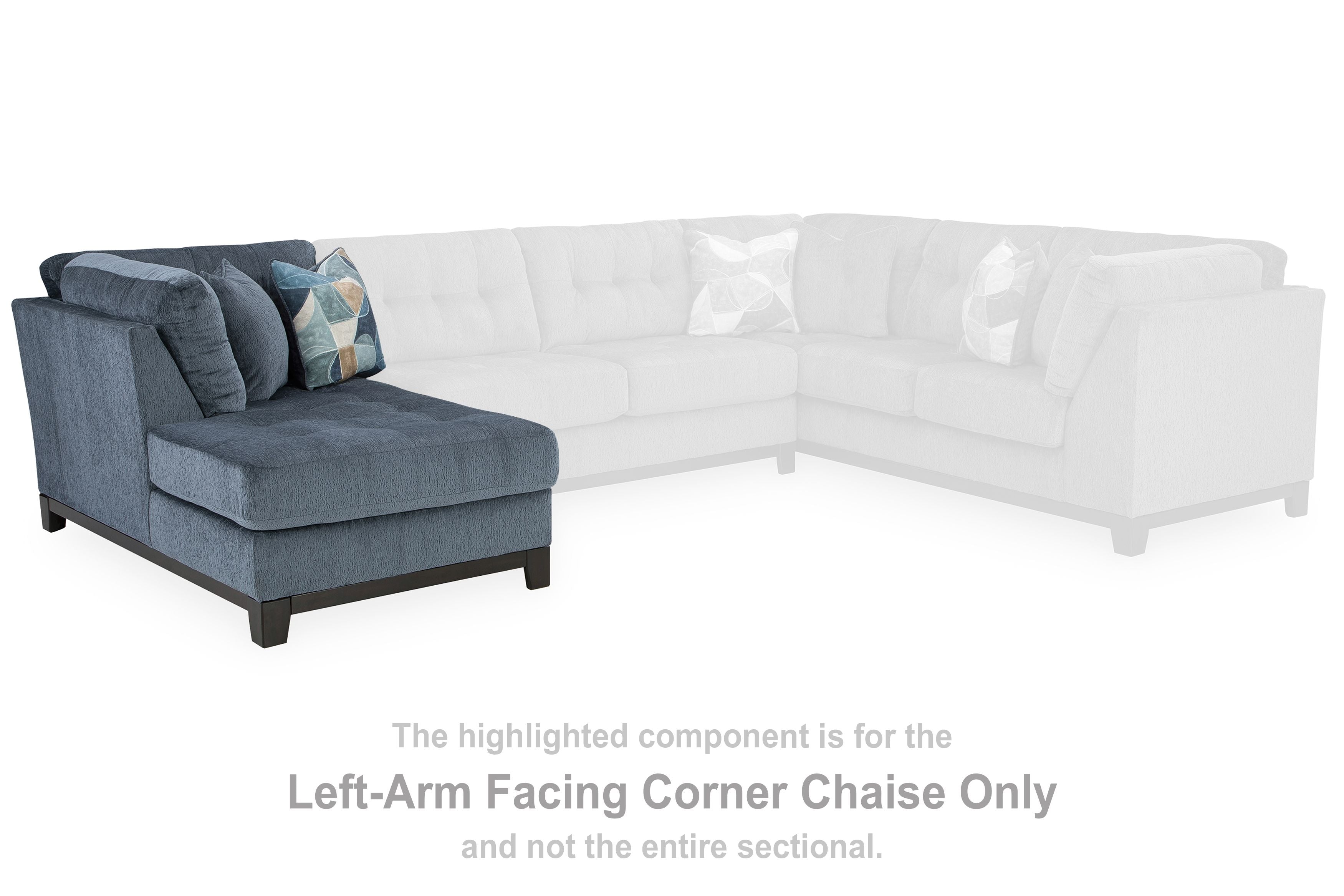 Left-facing navy corner chaise with geometric throw pillow, dark wooden legs