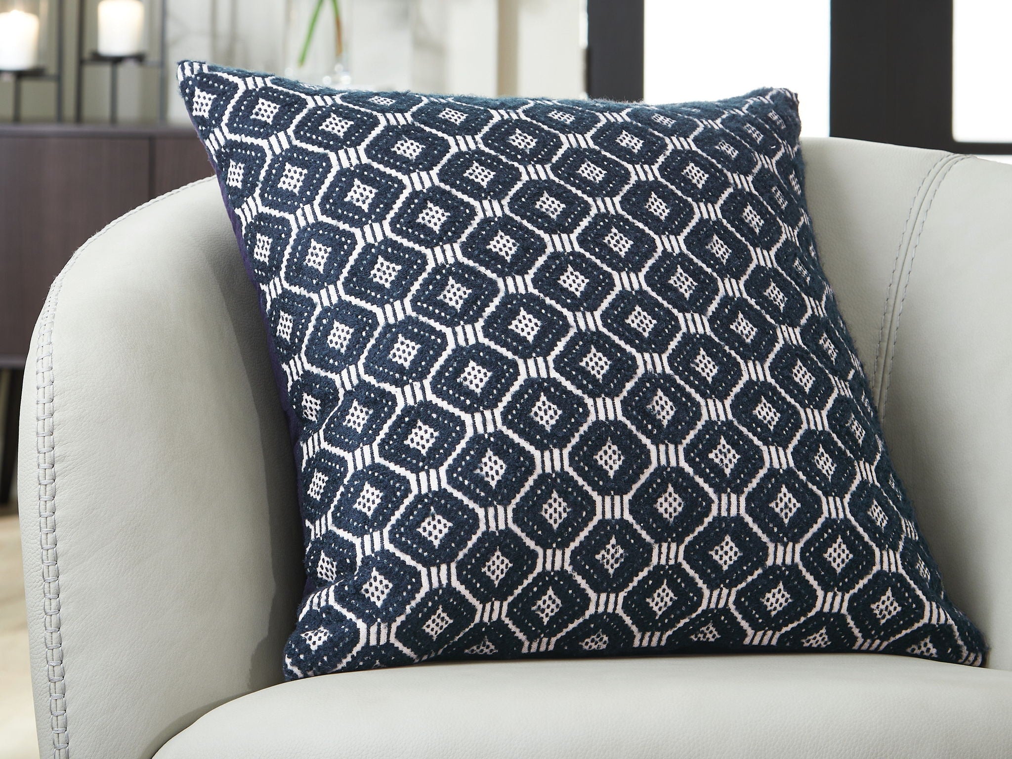 Abra decorative pillow with navy-and-white geometric diamond pattern, front close-up