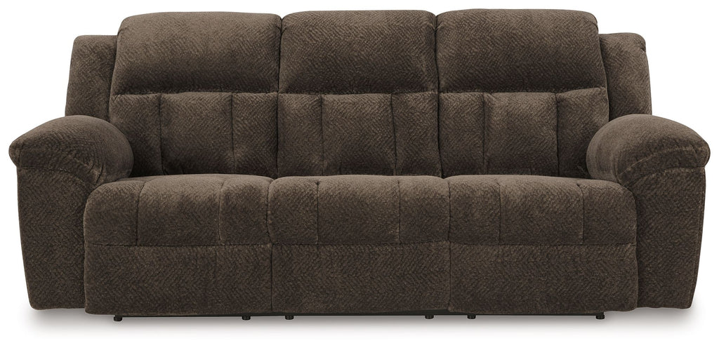Chocolate brown reclining sofa with tufted seat and back, padded arms, and angled cushions