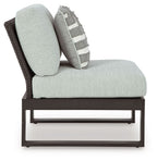 Outdoor sectional chair with chaise-style seat, light gray upholstery, black legs and frame