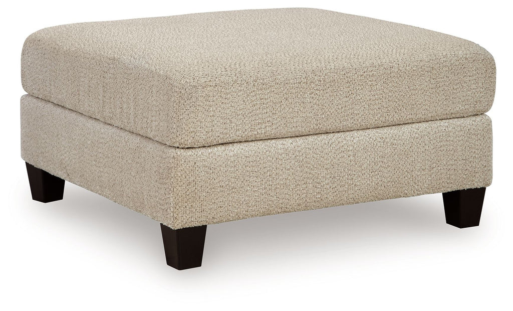 Latte oversized accent ottoman with boxy cushioned seat and tapered dark legs
