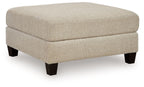 Latte oversized accent ottoman with boxy cushioned seat and tapered dark legs
